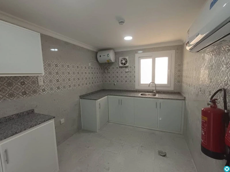 For rent, a building in Al-Khor, 13 apartments, and parking spaces. - 3/8